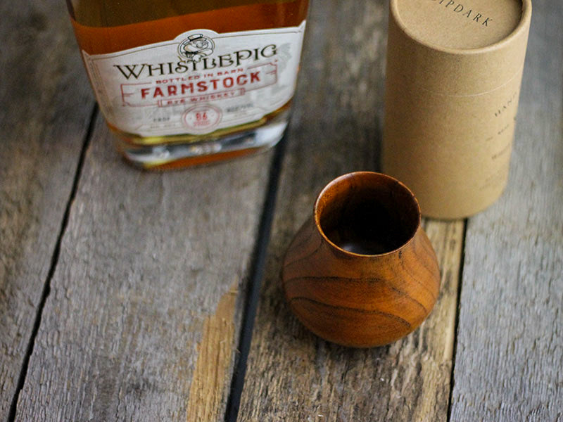 sipdark wood whisky glass on wood